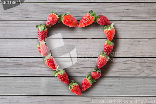 Image of heart shaped frame made of strawberries