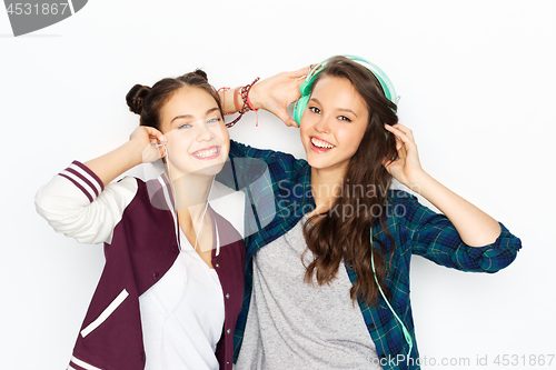 Image of teenage girls in earphones listening to music