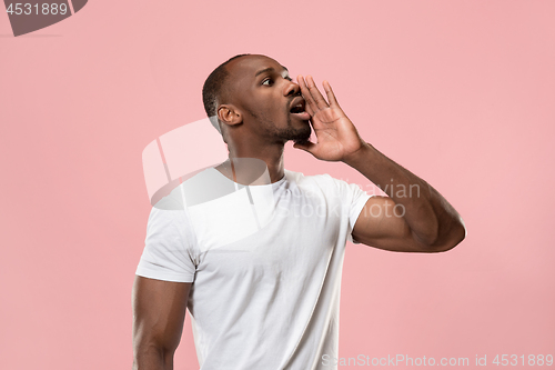 Image of Isolated on pink young casual man shouting at studio