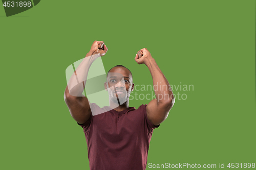 Image of Winning success man happy ecstatic celebrating being a winner. Dynamic energetic image of male model