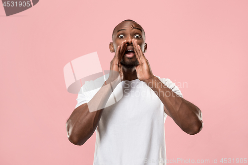 Image of Isolated on pink young casual man shouting at studio