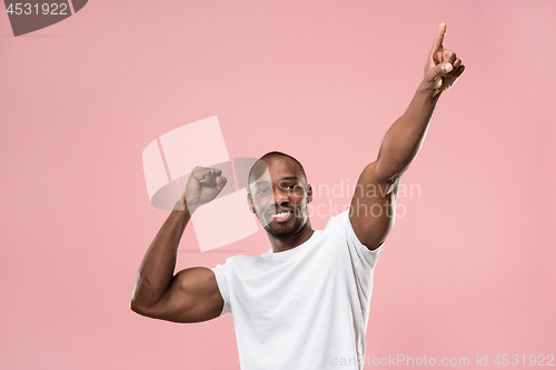 Image of Winning success man happy ecstatic celebrating being a winner. Dynamic energetic image of male model