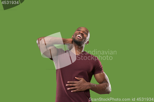 Image of The happy businessman standing and smiling against green background.