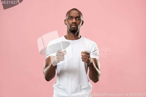 Image of The overbearing businessman point you and want you, half length closeup portrait on pink background.