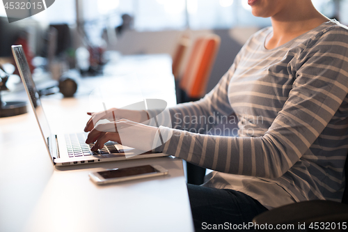 Image of businesswoman using a laptop in startup office