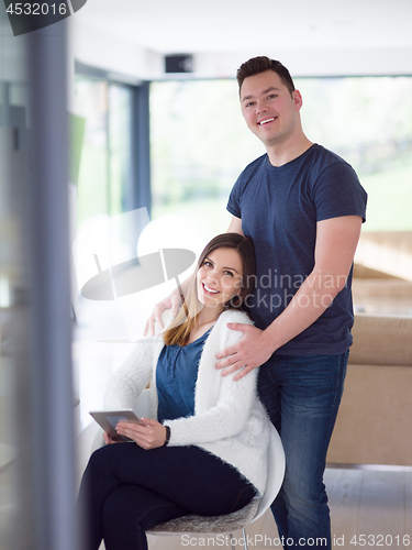 Image of couple using tablet at home