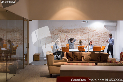 Image of Group of young business people throwing documents