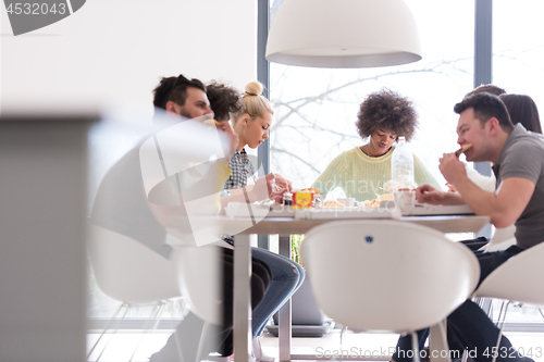 Image of multiethnic group of happy friends lunch time