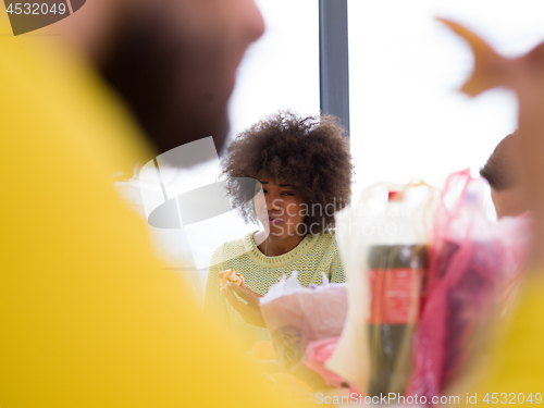 Image of multiethnic group of happy friends lunch time