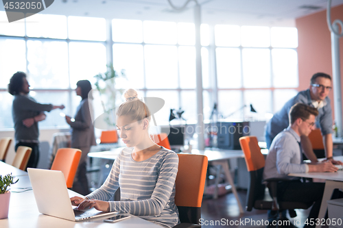 Image of businesswoman using a laptop in startup office