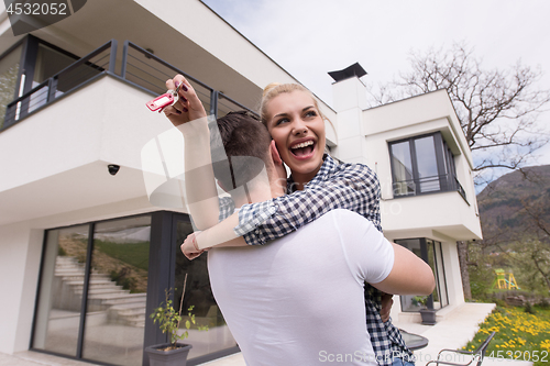 Image of couple hugging in front of  new luxury home