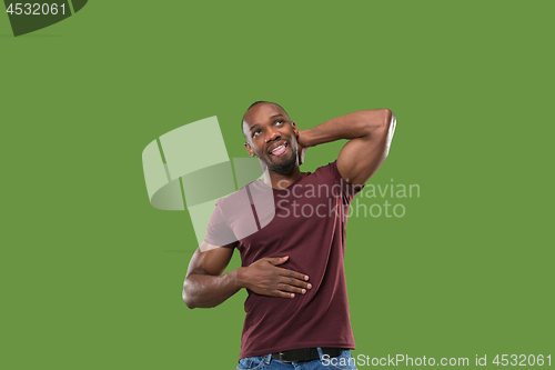 Image of The happy businessman standing and smiling against green background.