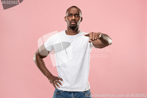Image of The overbearing businessman point you and want you, half length closeup portrait on pink background.