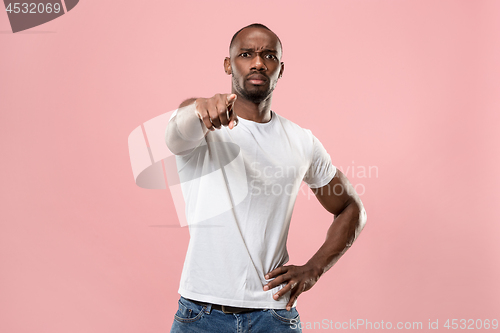 Image of The overbearing businessman point you and want you, half length closeup portrait on pink background.