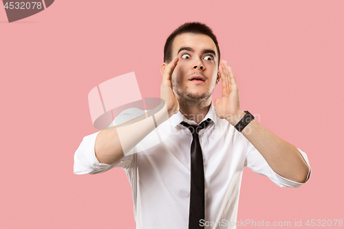 Image of Isolated on pink young casual man shouting at studio