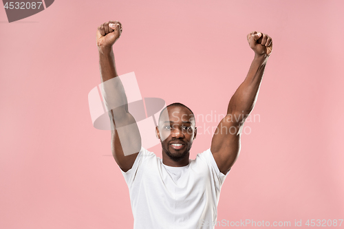 Image of Winning success man happy ecstatic celebrating being a winner. Dynamic energetic image of male model