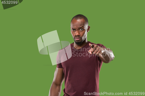 Image of The overbearing businessman point you and want you, half length closeup portrait on green background.