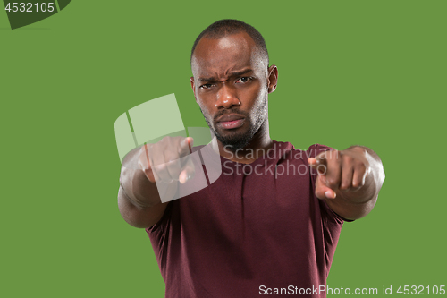 Image of The overbearing businessman point you and want you, half length closeup portrait on green background.