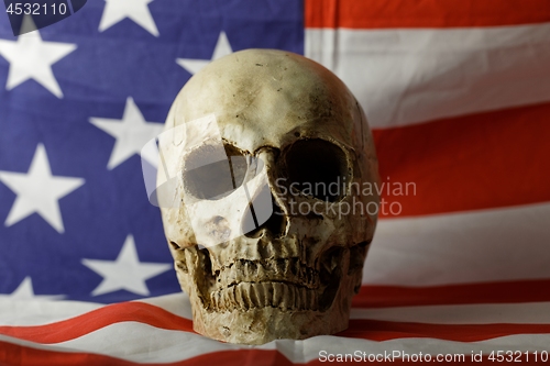 Image of Human skull against american flag