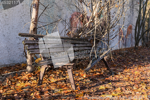 Image of Old destroyed bench next to path