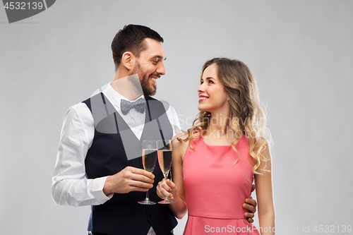 Image of happy couple with champagne glasses toasting