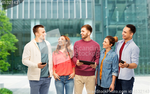 Image of students with gadgets over university background