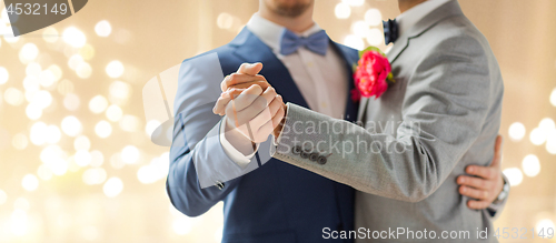 Image of close up of happy male gay couple dancing