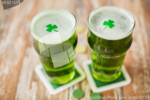 Image of glasses of green beer with shamrock and gold coins