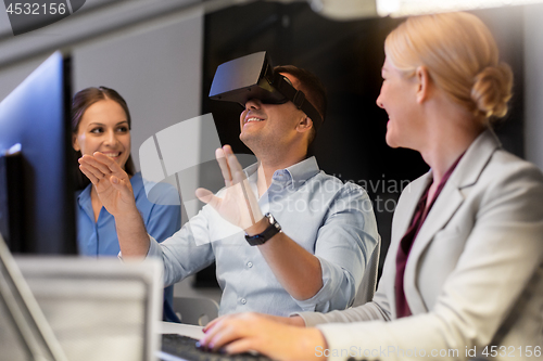 Image of business team with computer working late at office