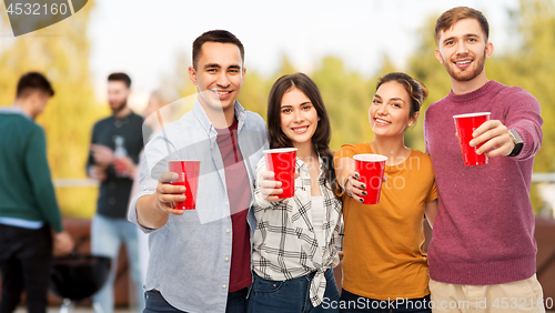 Image of group of friends toasting drinks at rooftop party