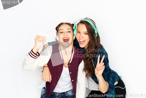 Image of teenage girls in earphones listening to music