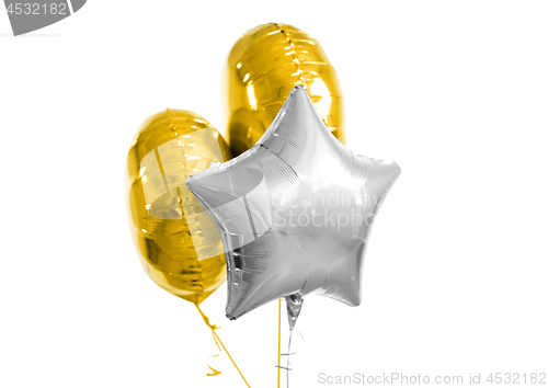 Image of three gold and silver helium balloons on white