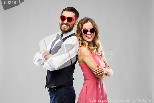 Image of happy couple in heart-shaped sunglasses