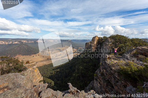 Image of Adventurous hiker explorer reaching the top slab of Donkey Mount