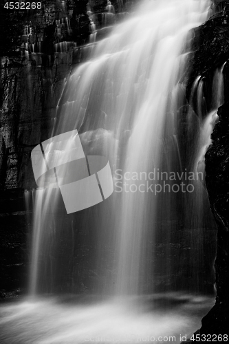 Image of Powerful waterfall flowing down cliff ledge
