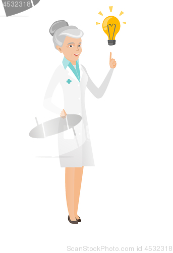 Image of Senior caucasian doctor pointing at idea lightbulb