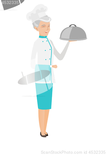 Image of Senior caucasian chef holding towel and cloche.