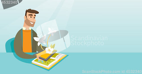 Image of Young man holding tablet computer above the book.