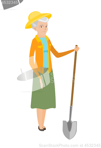 Image of Senior caucasian farmer holding a shovel.