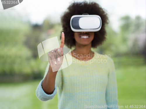 Image of black woman using VR headset glasses of virtual reality