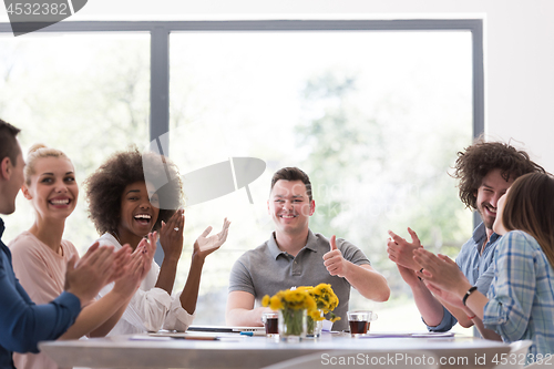 Image of multiethnic startup Group of young business people celebrating s