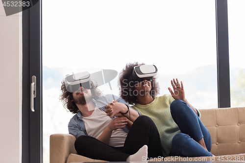 Image of Multiethnic Couple using virtual reality headset