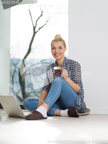 Image of young woman drinking coffee enjoying relaxing lifestyle