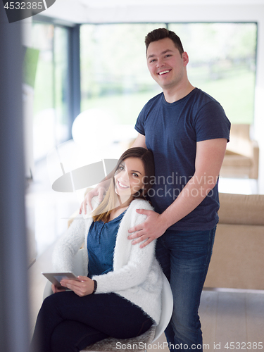 Image of couple using tablet at home