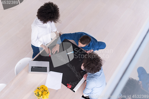 Image of top view of Multiethnic startup business team on meeting