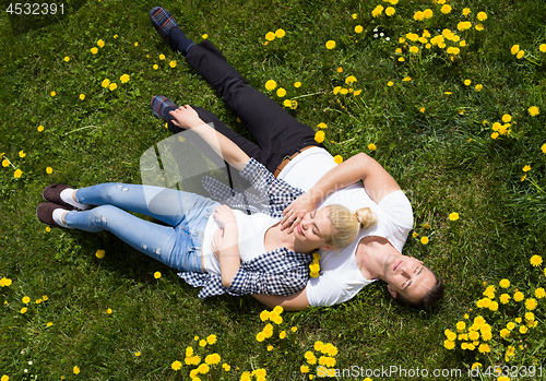 Image of man and woman lying on the grass