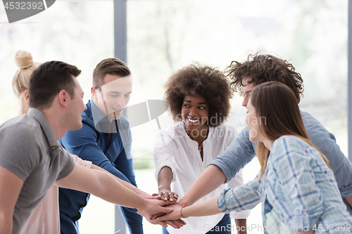 Image of multiethnic startup Group of young business people celebrating s