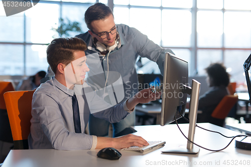 Image of Two Business People Working With computer in office