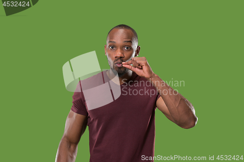 Image of The young man whispering a secret behind her hand