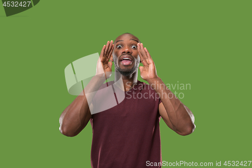 Image of young casual man shouting at studio